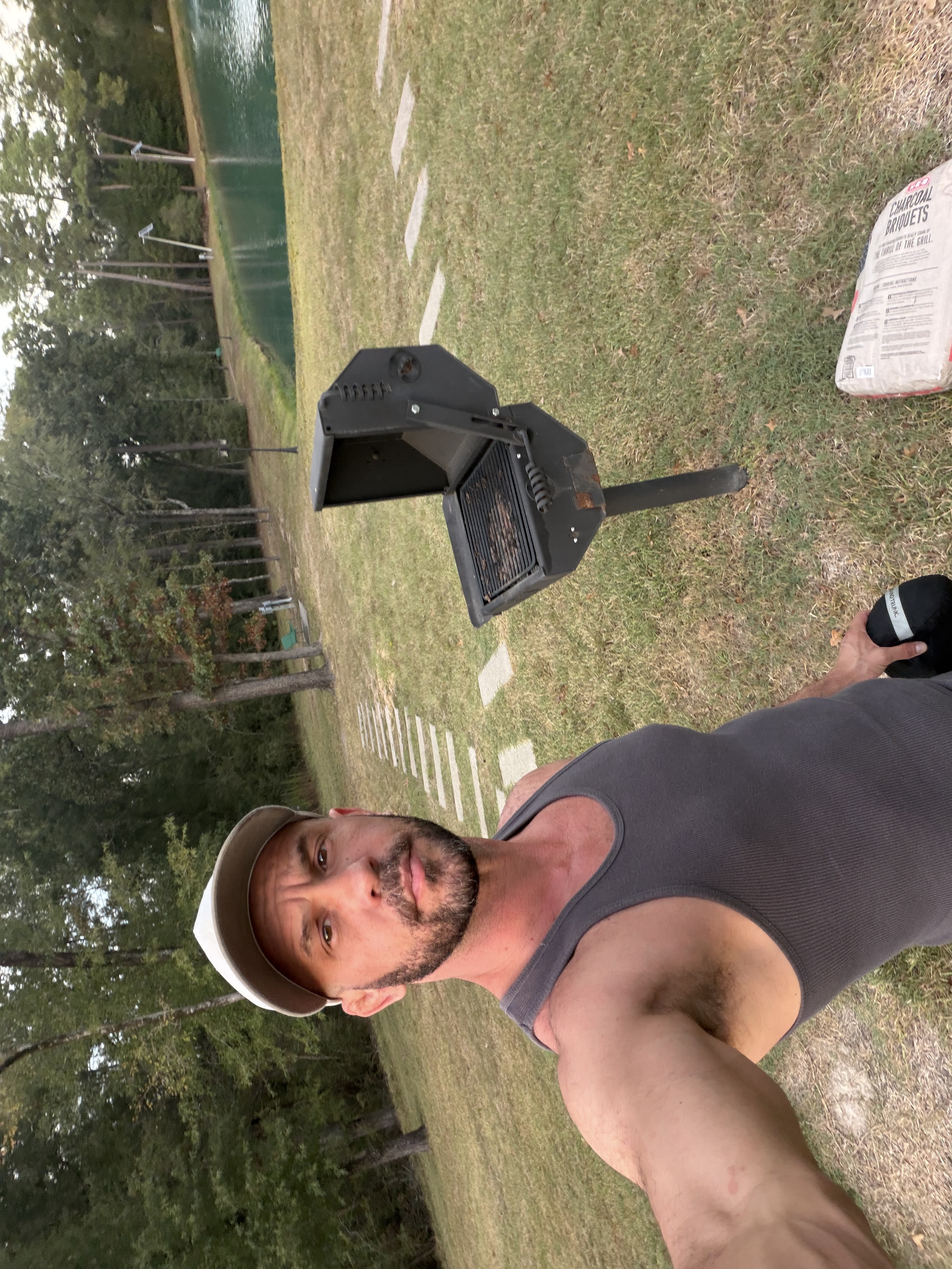 Original selfie beside a grill and lake